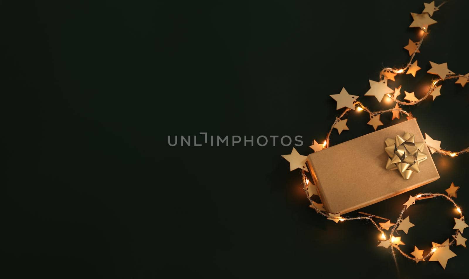 Christmas composition. Xmas background. Christmas gift and decoration elements on the dark background, fairy lights. Free space for text, copy space. Flat lay, top view by creativebird