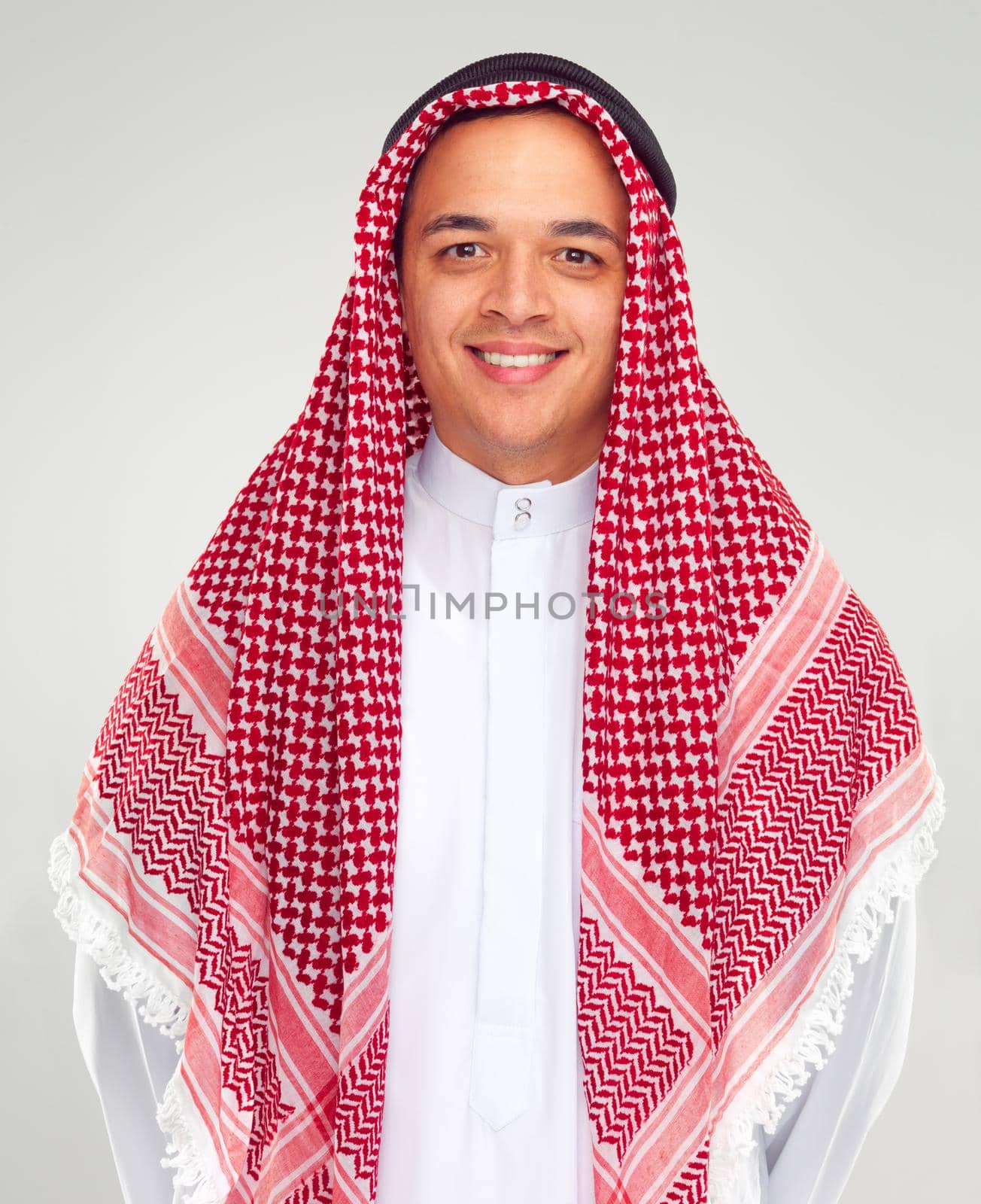 Traditional pride. Studio portrait of a young arabic man in a keffiyeh