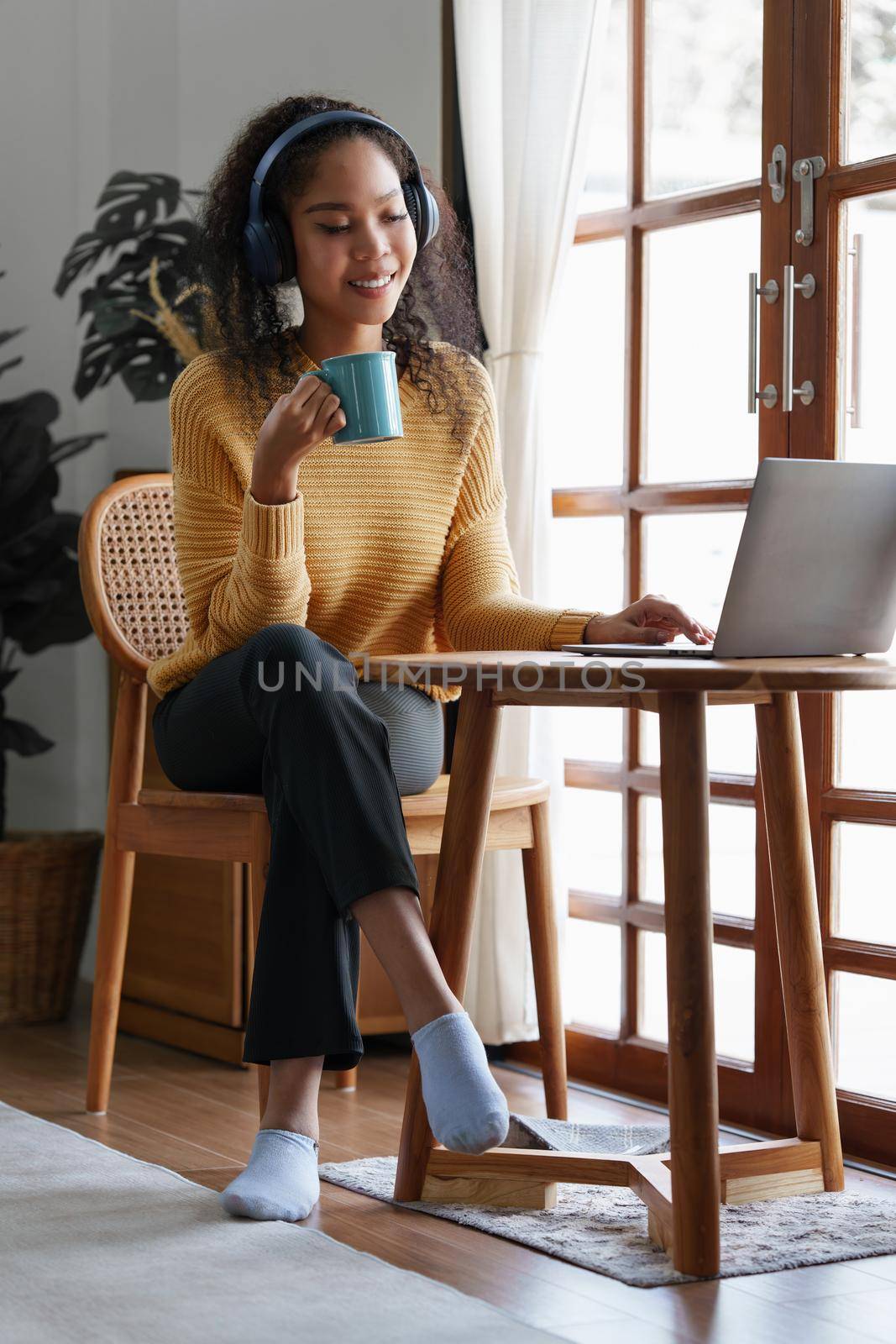 Beautiful woman relaxing and drinking coffee in morning at home.