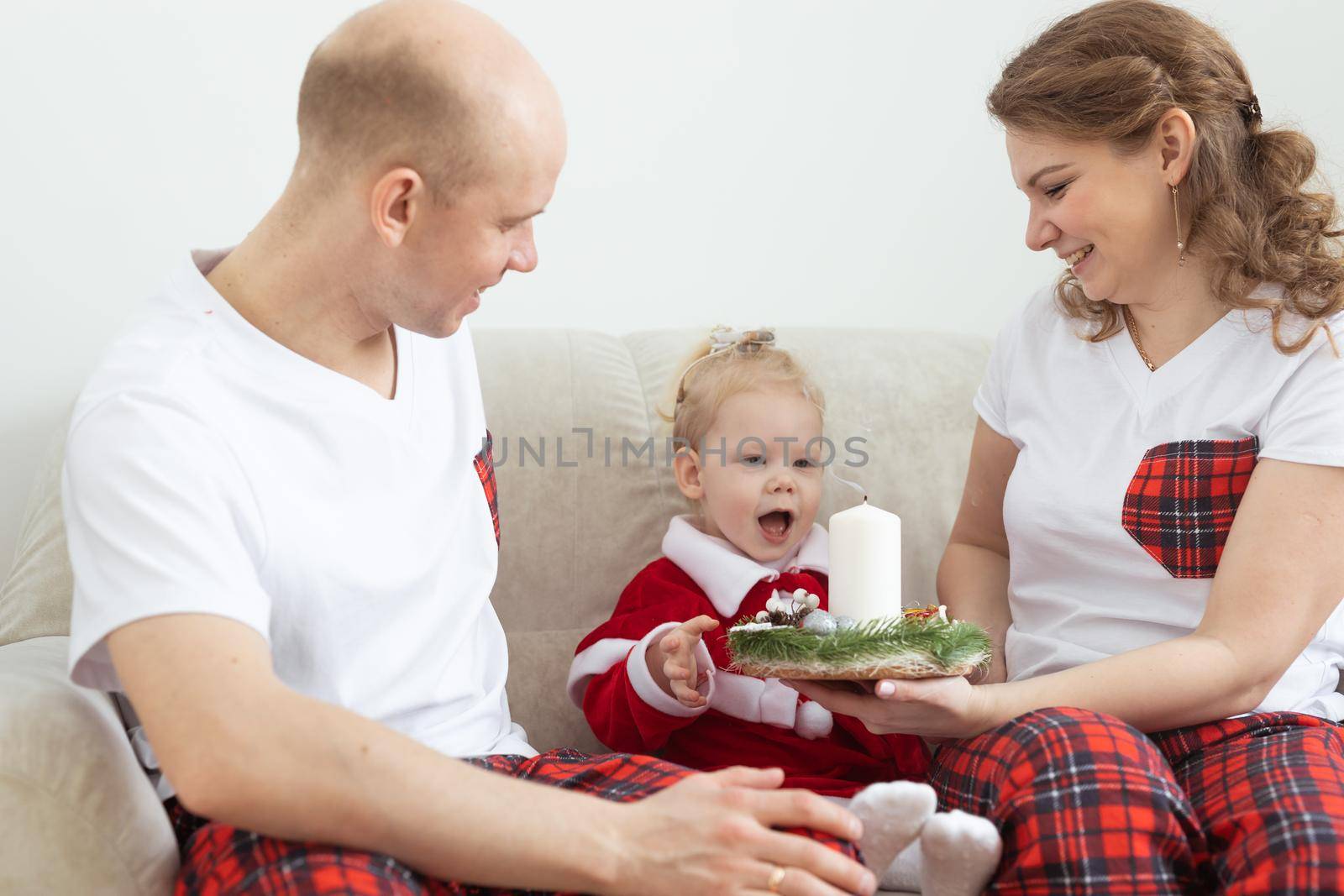 Child with cochlear implant hearing aid having fun with parents in christmas living room - diversity , deafness treatment and medical innovative technologies by Satura86