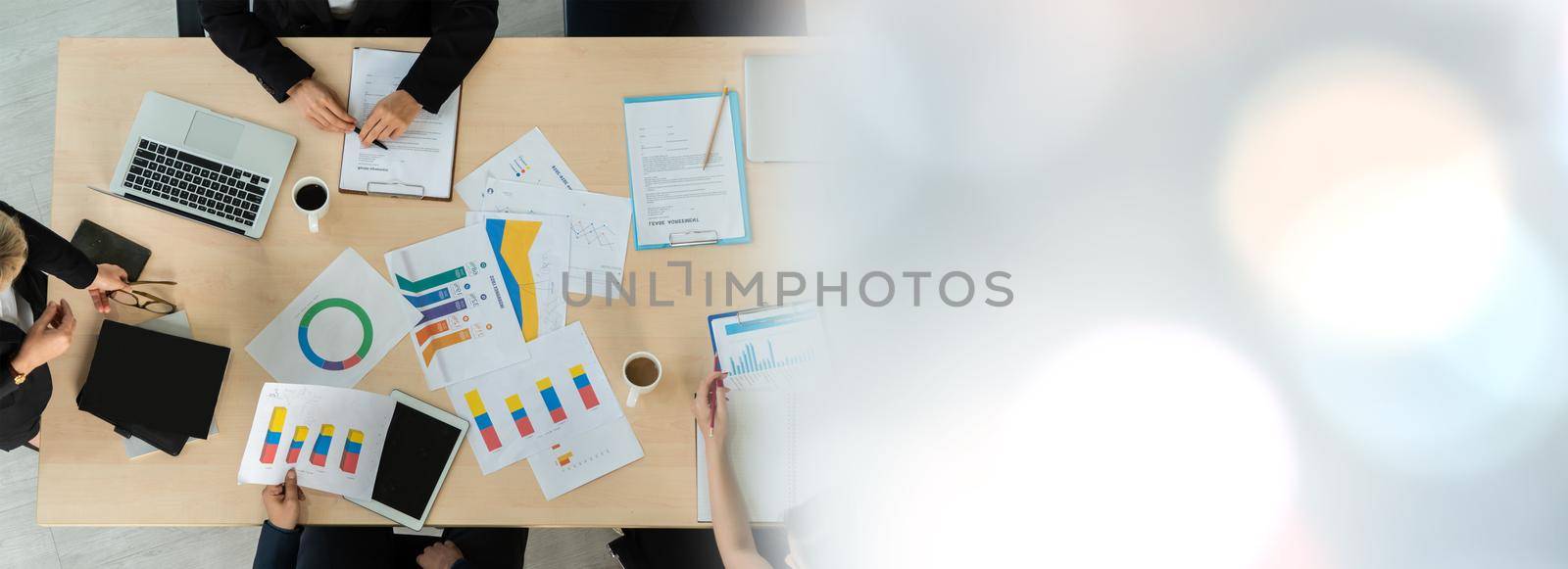 Business people group meeting shot from top widen view in office . Profession businesswomen, businessmen and office workers working in team conference with project planning document on meeting table .