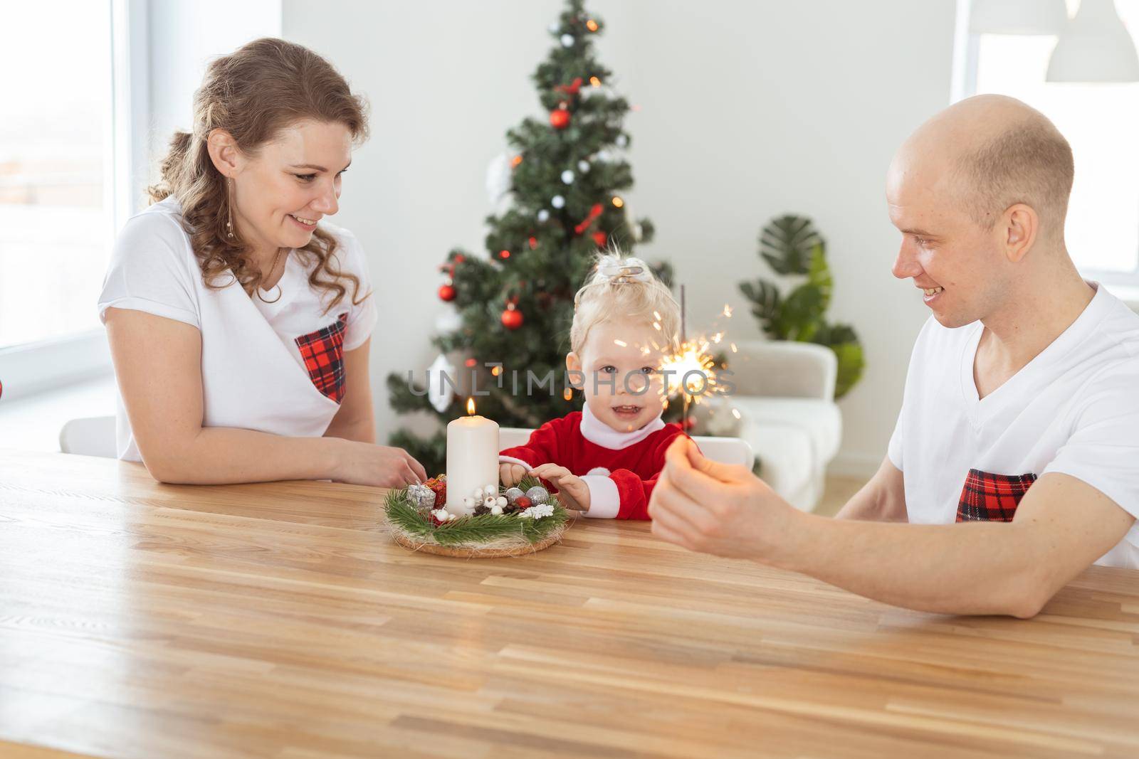 Child girl dressed in christmas dress with cochlear implants having fun at home - diversity and hearing aid and innovating technologies for treatment of deafness. by Satura86