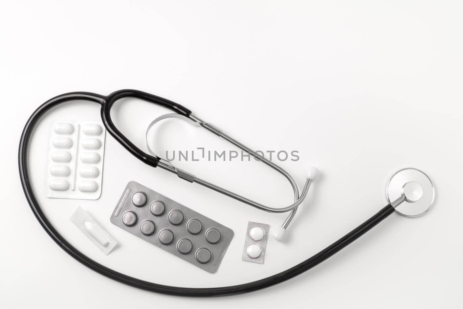Medical equipment on white background. Stethoscope, pills, tablets. Medical tools. Medicine and healthcare. Free space for text, copy space