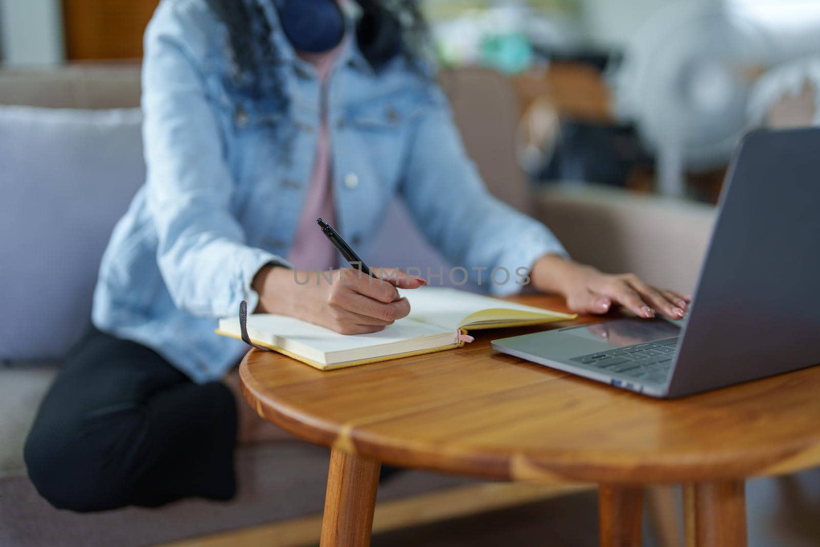 African Americans using notebooks, pens to take notes and computers by Manastrong