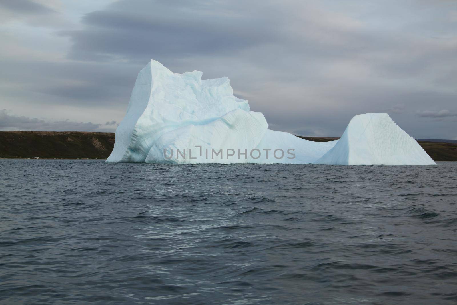 Stranded iceberg and ice near evening in arctic landscape, near Pond Inlet, Nunavut by Granchinho