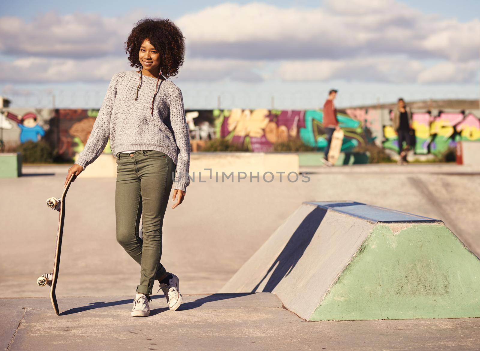 Why walk when you can skate. a young woman out skateboarding in the city. by YuriArcurs