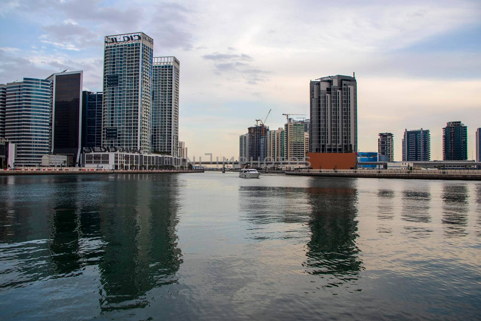 Modern buildings along the Dubai water canal, business bay district UAE by pazemin