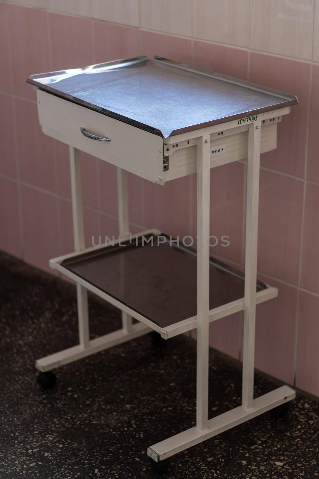 Image of old pink gynecological chair in toffice room professional clinic with copy space. Pregnancy Planning parturition lying-in maternity pain obstetrics Concept by mytrykau