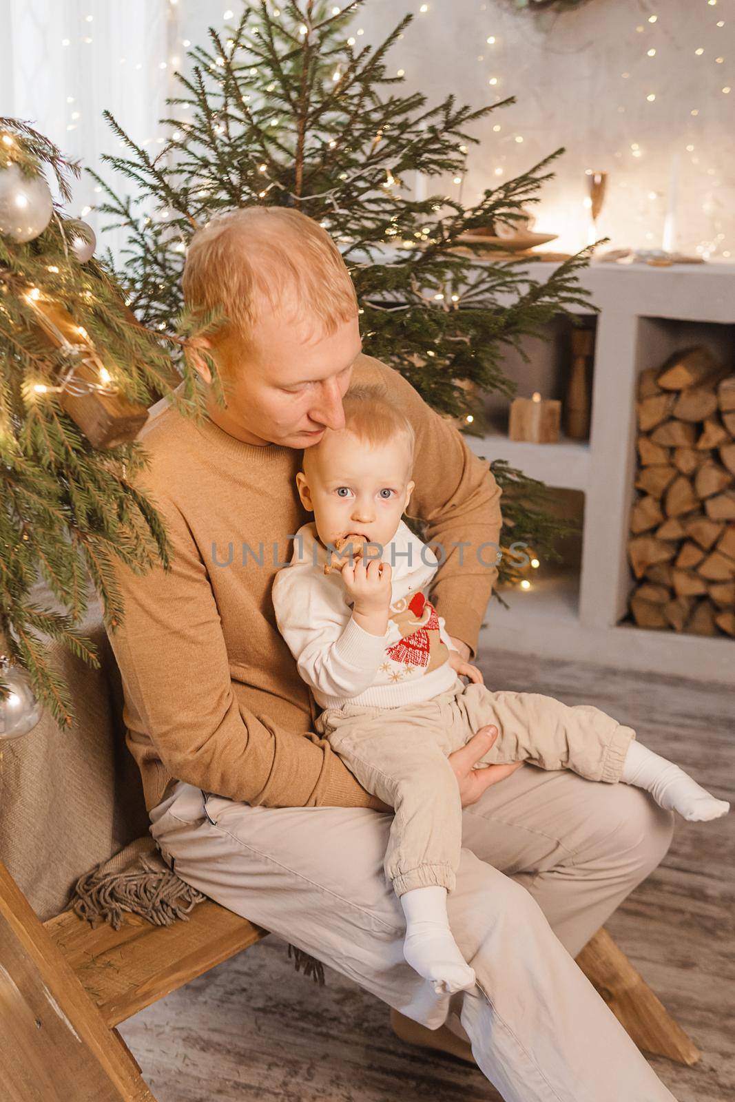 Dad and his little son in a magical Christmas atmosphere. The concept of family relations and New Year celebrations