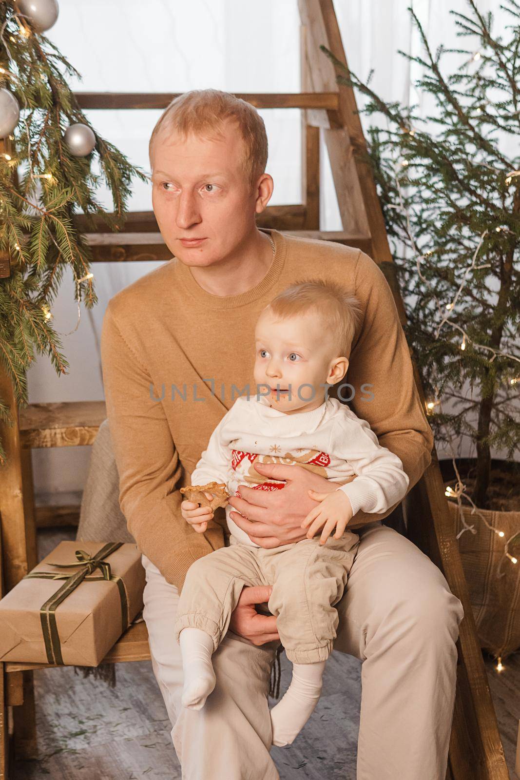 Dad and his little son in a magical Christmas atmosphere. The concept of family relations and New Year celebrations