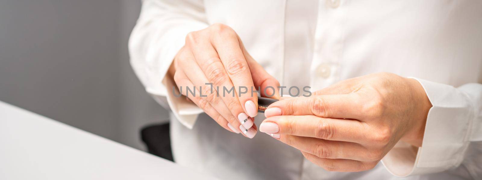 Professional manicurist preparing tools for doing clients nails