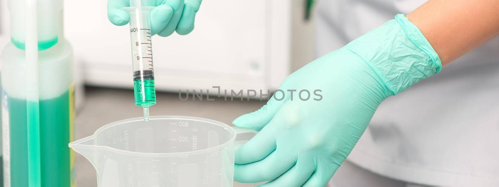 The beautician uses a syringe to add disinfectant to the water. Sterilization of tools