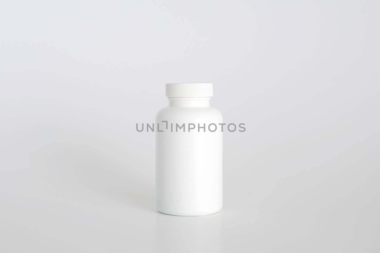 Pills bottle. White medical container for drugs, diet, nutritional supplements. White plastic jar for pills. Packaging mockup template. Free space, copy space. by creativebird
