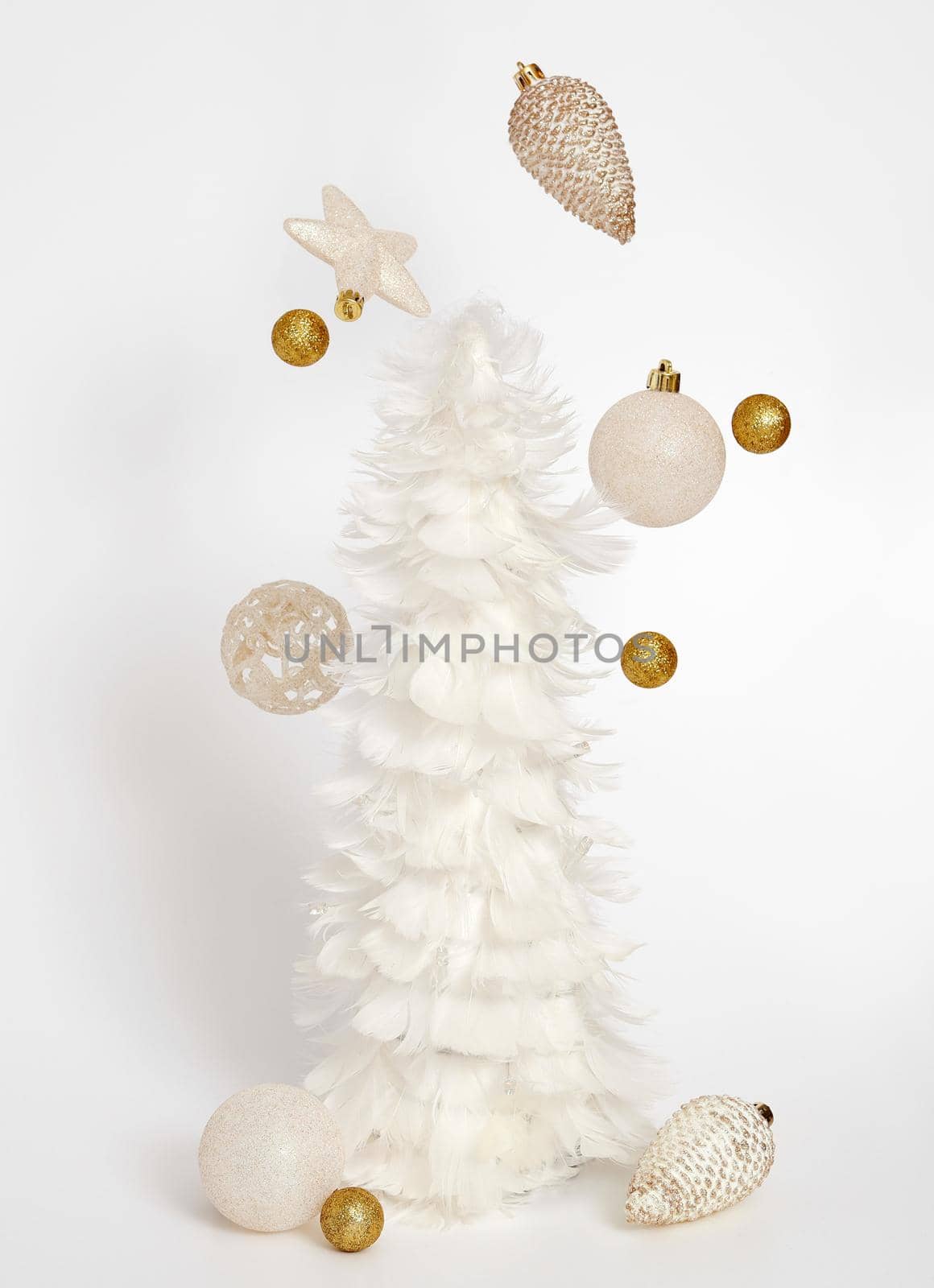 White Christmas tree and flying decoration on the white background. Christmas composition. Modern Xmas background. by creativebird