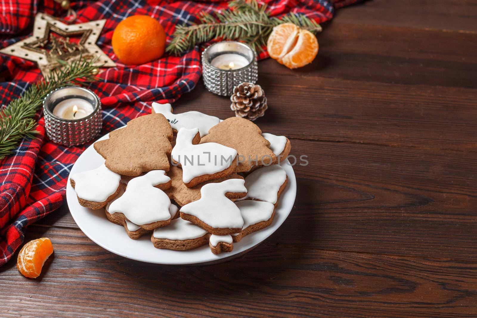 Delicious homemade Christmas cookies in the form of a rabbit and a Christmas tree on a wooden table decorated with New Year's decor. Copy spase by lara29