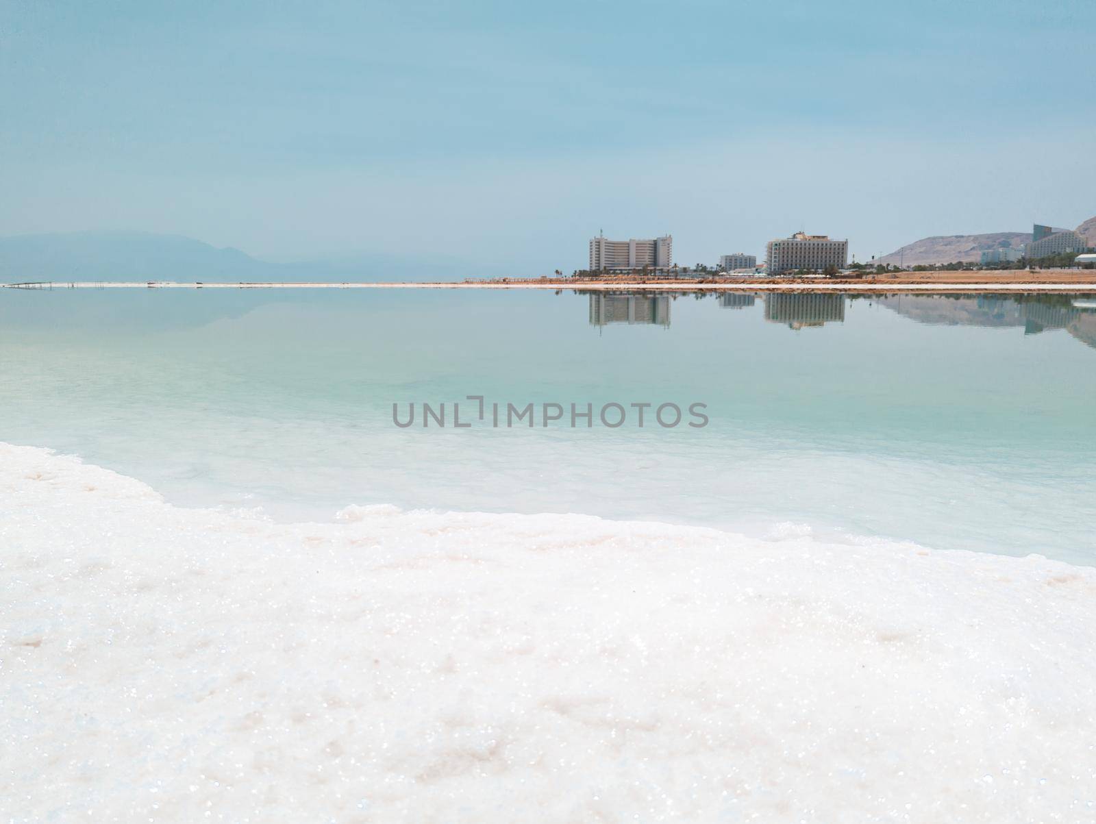 Landscape view on Dead Sea salt crystals formations, clear cyan green water at Ein Bokek beach, Israel by Len44ik