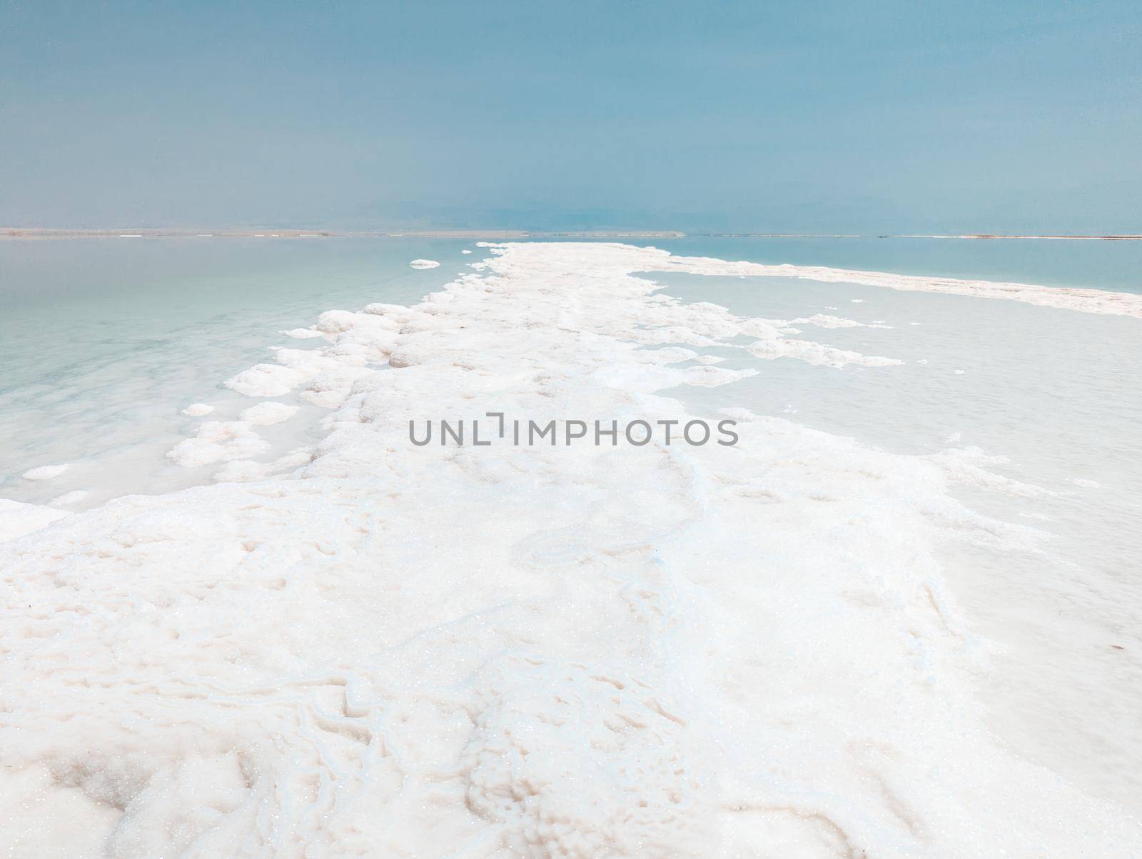 Landscape view on Dead Sea salt crystals formations, clear cyan green water at Ein Bokek beach, Israel by Len44ik