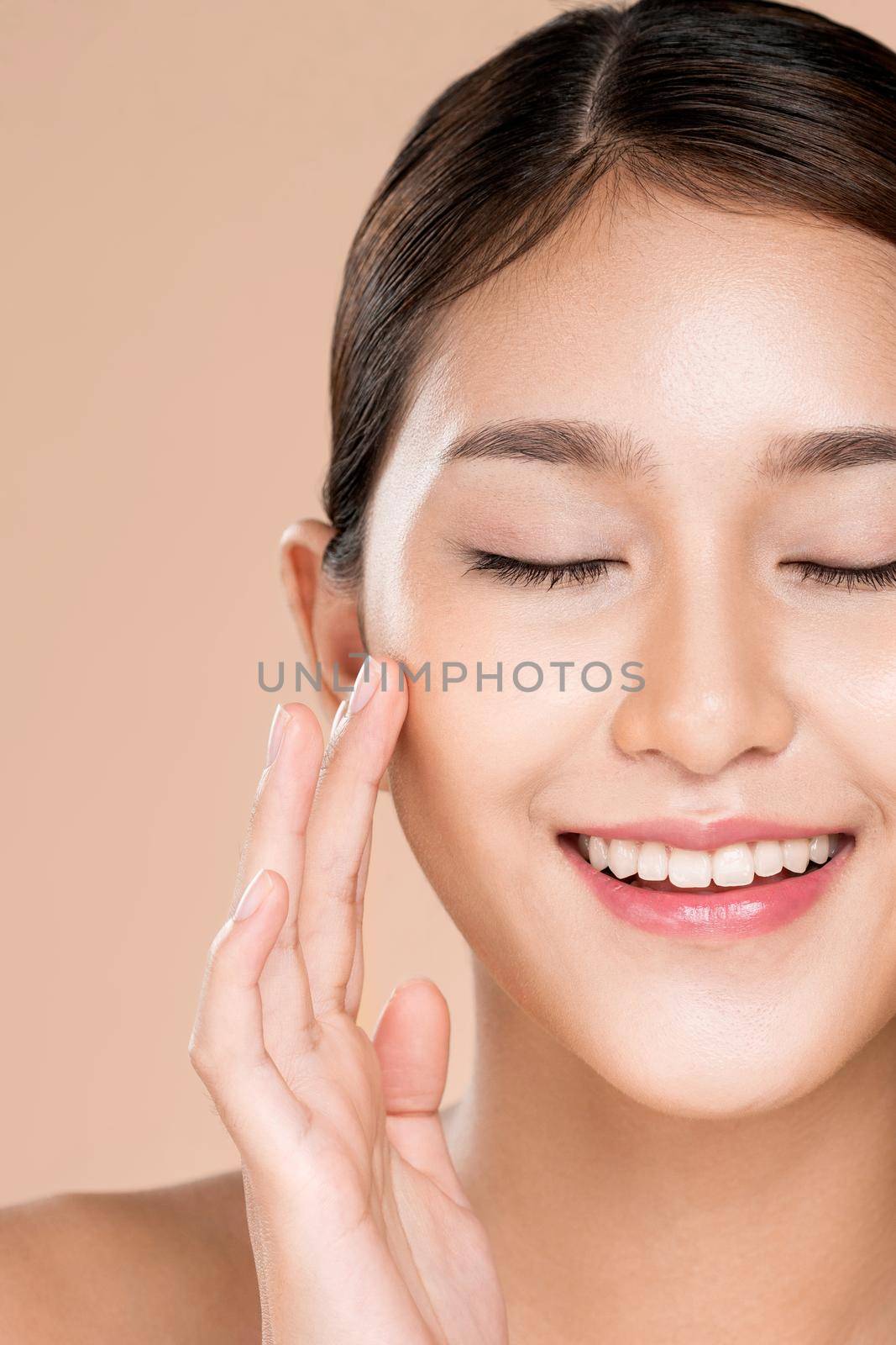Closeup ardent young woman with healthy clear skin and soft makeup looking at camera and posing beauty gesture. Cosmetology skincare and beauty concept.