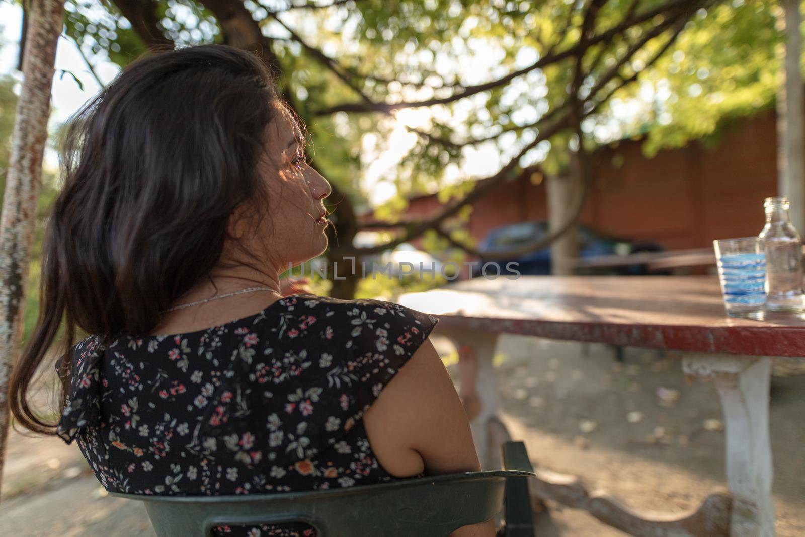 sexy hispanic young adult woman relaxing outdoors in summertime by verbano