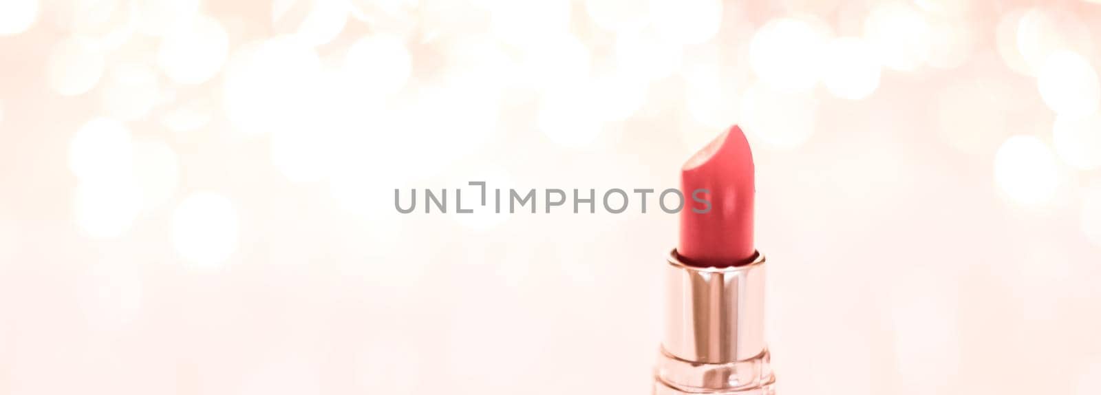 Cosmetic branding, sale and glamour concept - Coral lipstick on rose gold Christmas, New Years and Valentines Day holiday glitter background, make-up and cosmetics product for luxury beauty brand