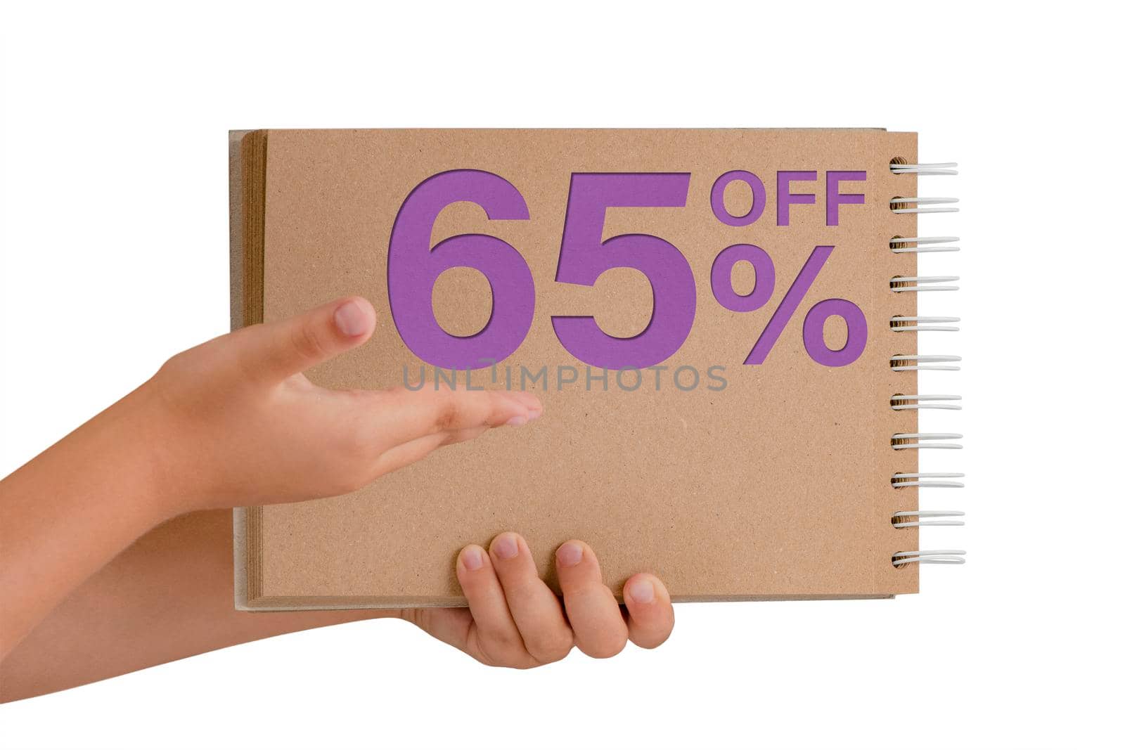 65 percent discount on isolate. Notepad from recycled paper in the hands of a child with text, sale up to 65 percent. The child is holding a notepad demonstrating a big sale