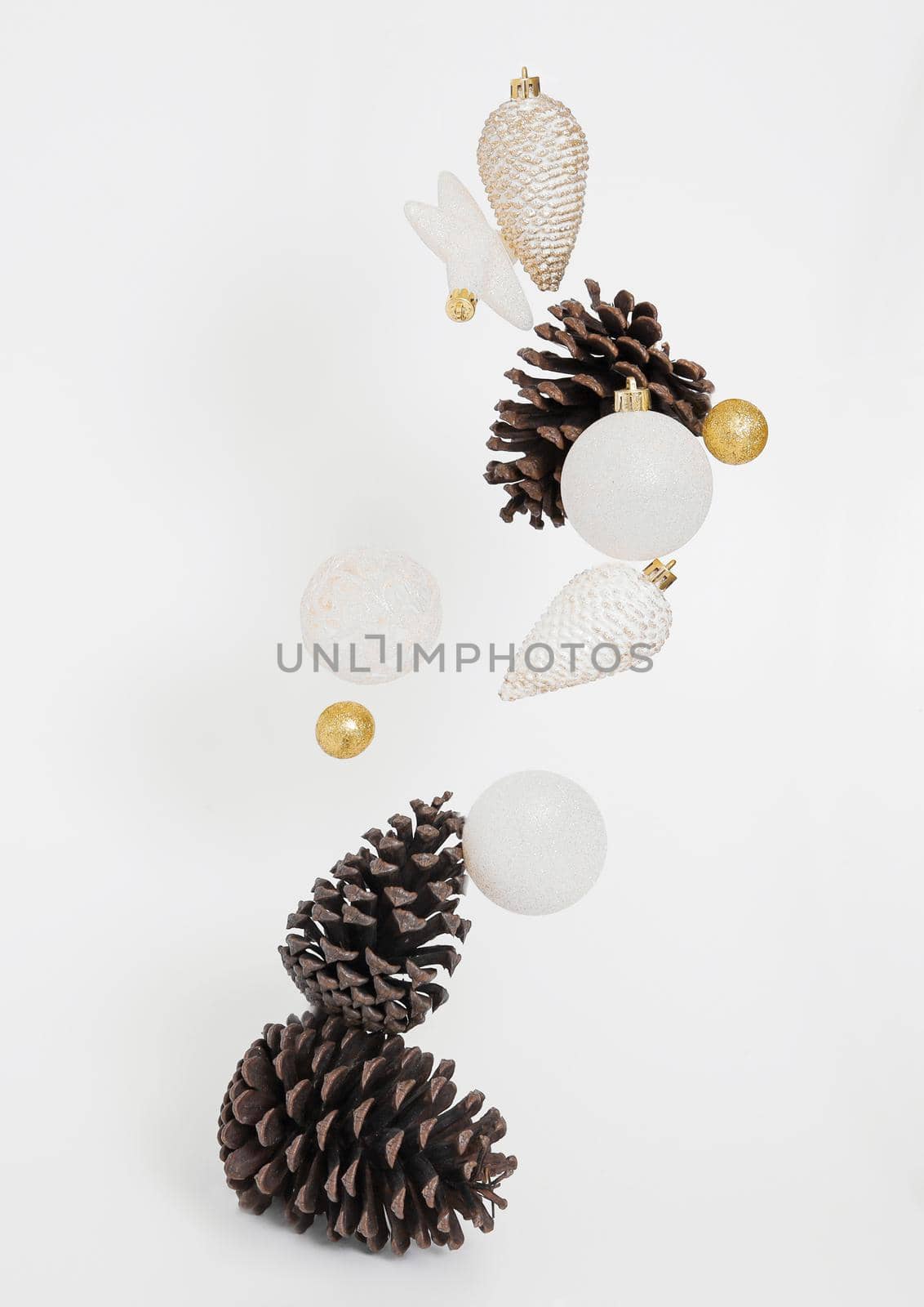 Flying Christmas decoration on the white background. Christmas composition. Free space, copy space. Modern Xmas background