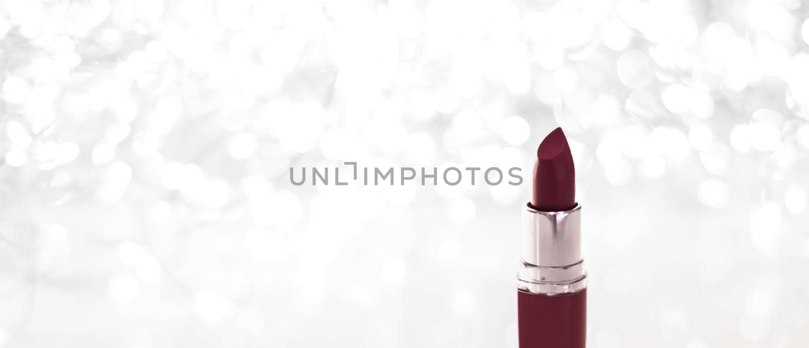 Cosmetic branding, sale and glamour concept - Chocolate lipstick on silver Christmas, New Years and Valentines Day holiday glitter background, make-up and cosmetics product for luxury beauty brand