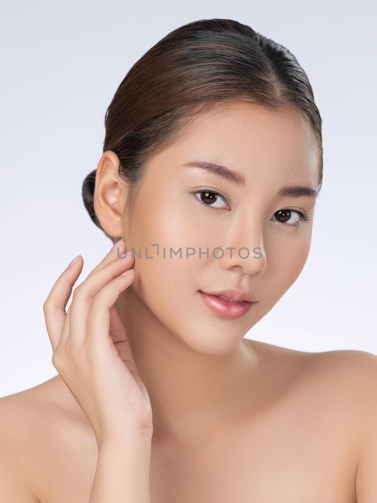 Portrait of gorgeous young girl posing beauty gesture with clean fresh skin. by biancoblue