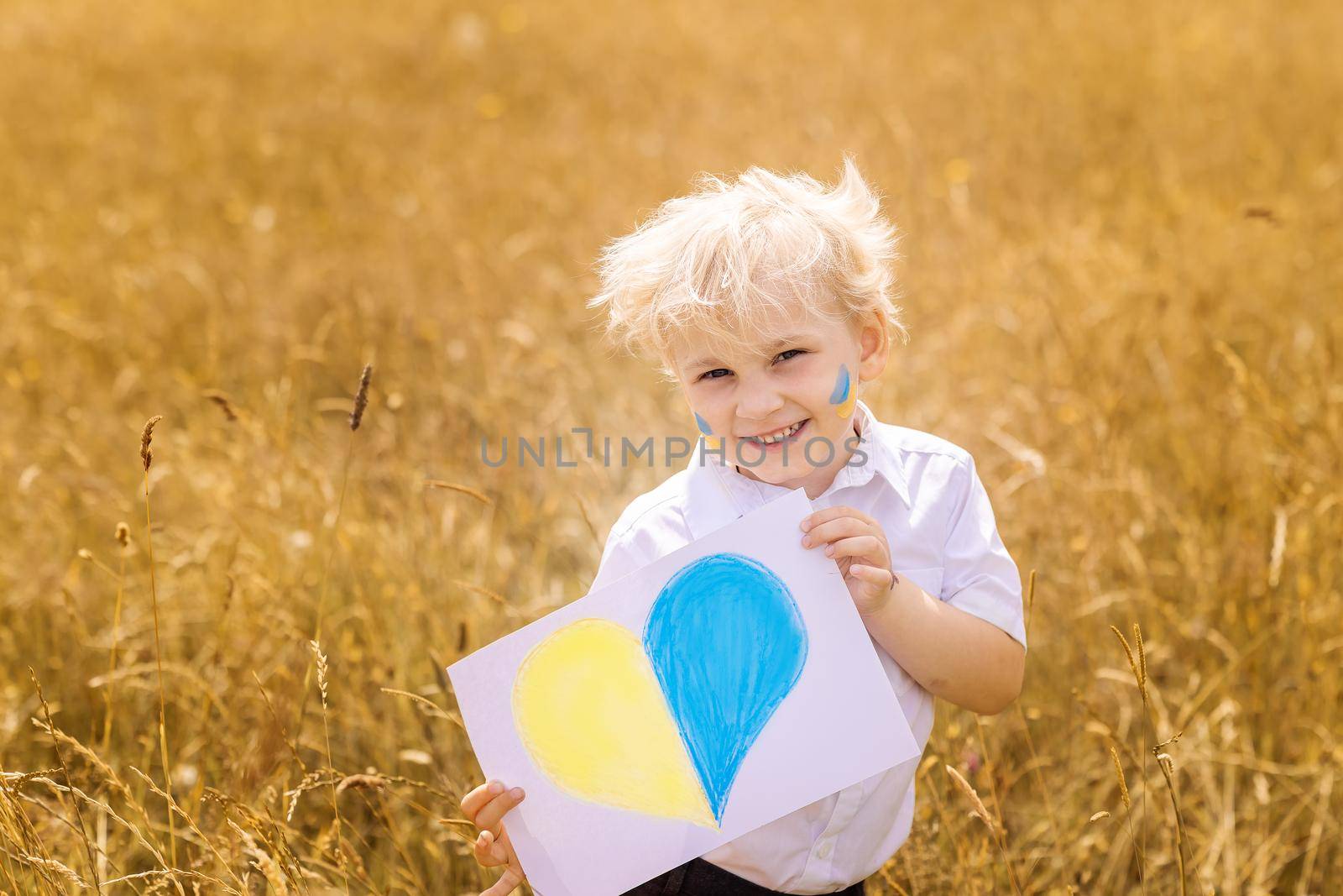 Stop War in Ukraine. Ukrainian boy with Ukrainina flag- yellow and blue stands against war. by Len44ik