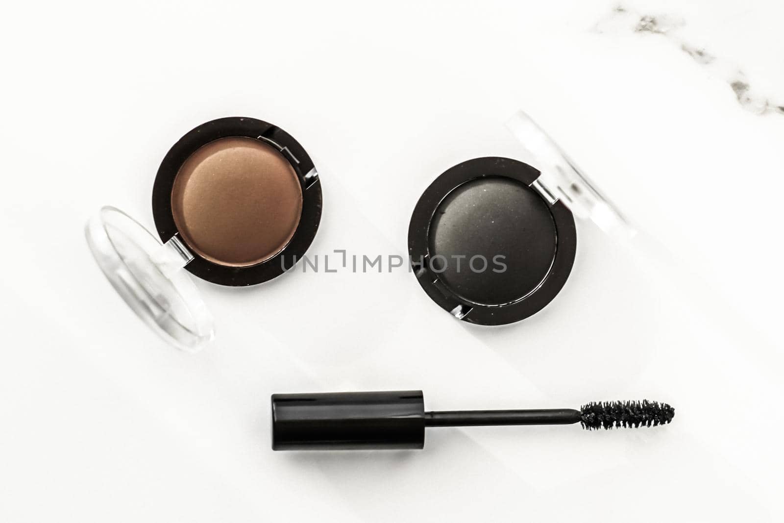 Eyeshadows, black liner and mascara on marble background, eye shadows cosmetics as glamour make-up products for luxury beauty brand, holiday flatlay design by Anneleven