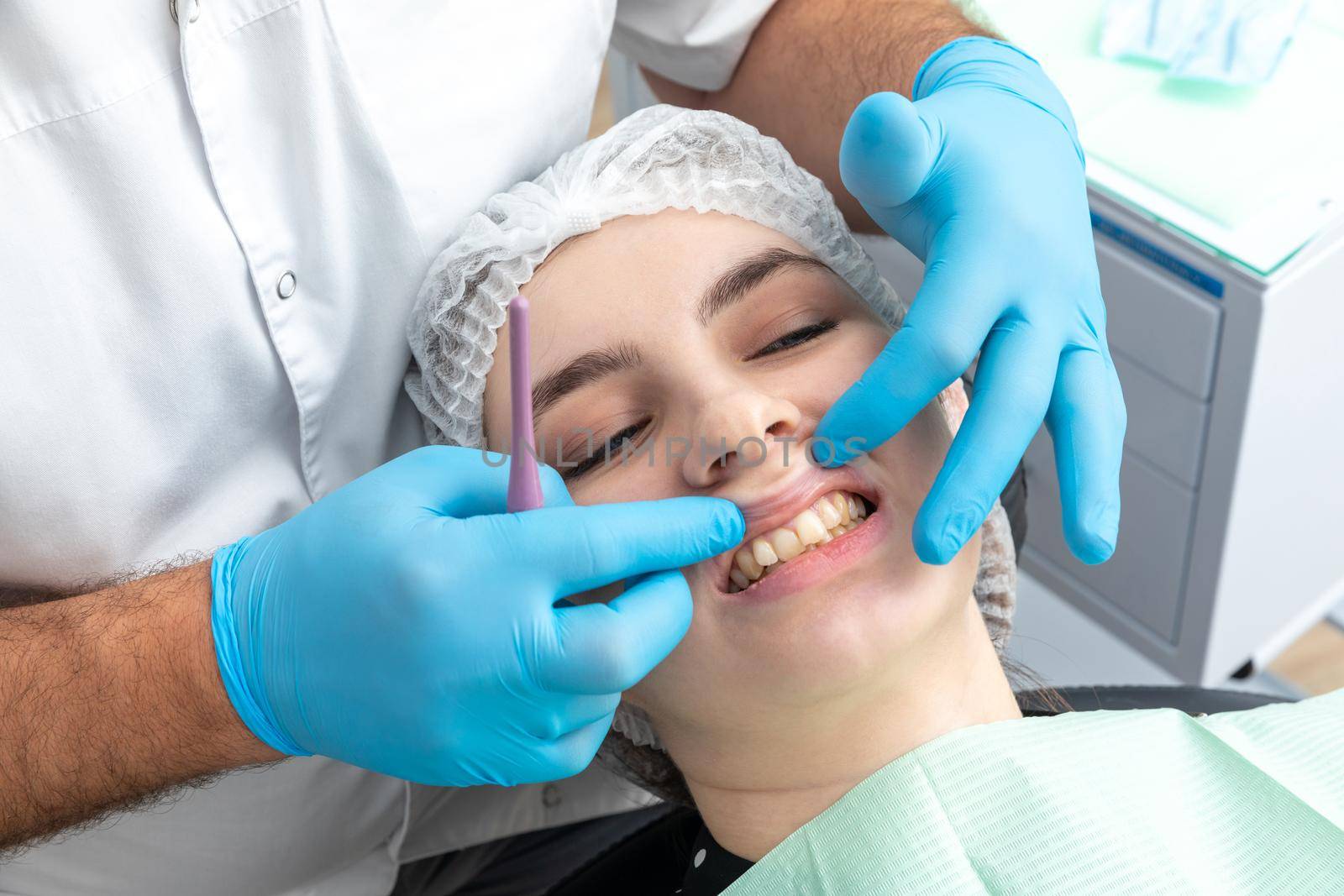 Male dentist looks at a jaw of female patient. Showing the bite to the doctor