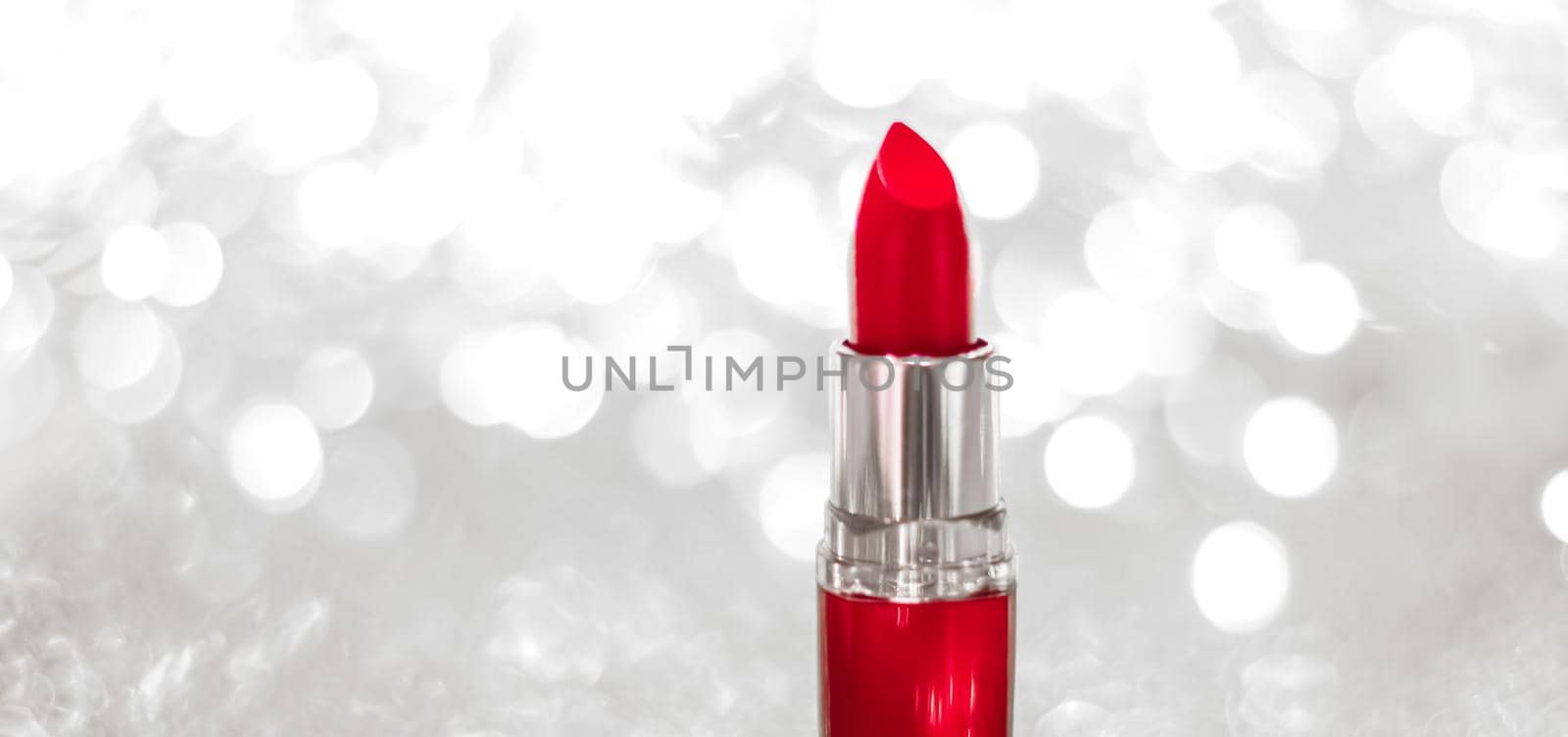 Cosmetic branding, sale and glamour concept - Red lipstick on silver Christmas, New Years and Valentines Day holiday glitter background, make-up and cosmetics product for luxury beauty brand