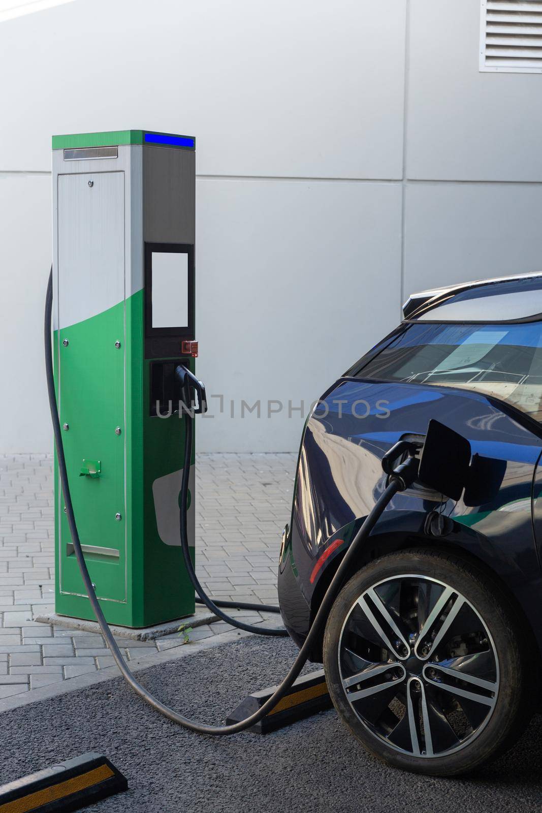 Power supply connect to electric vehicle for charge to the battery. Charging technology industry transport which are the futuristic of the Automobile. EV fuel Plug in hybrid car.