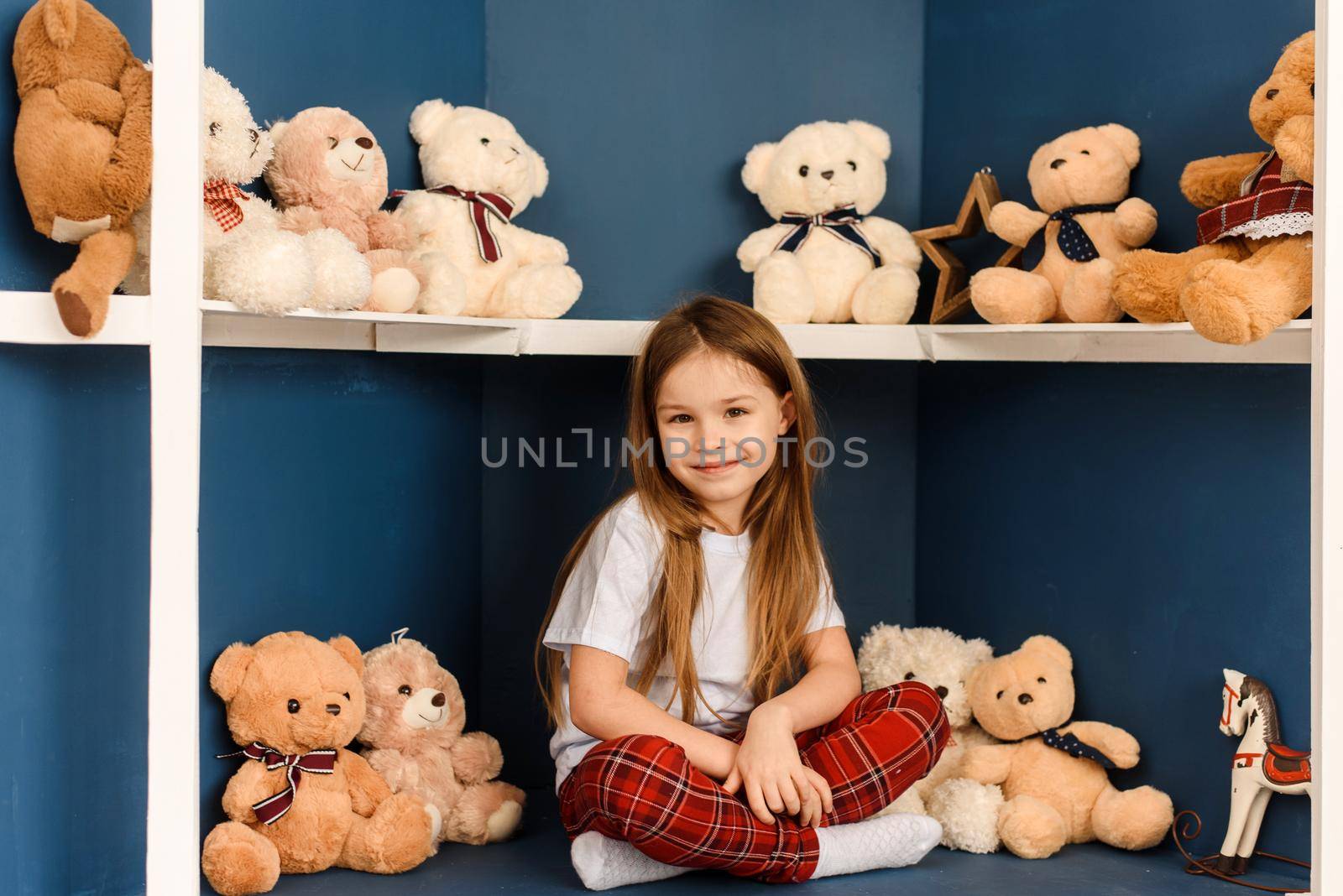 Christmas shopping in the toy store. Little cute girl with teddy bear by etonastenka