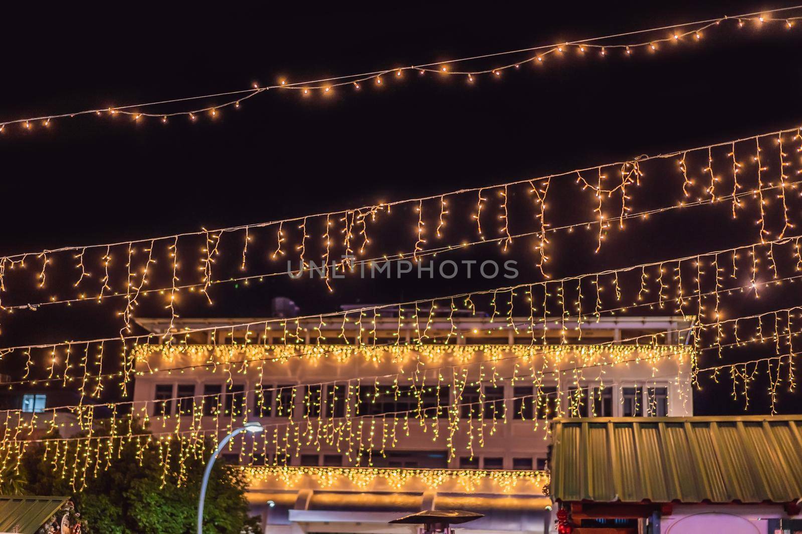 Illuminated swing chain carousel in amusement park at night by galitskaya