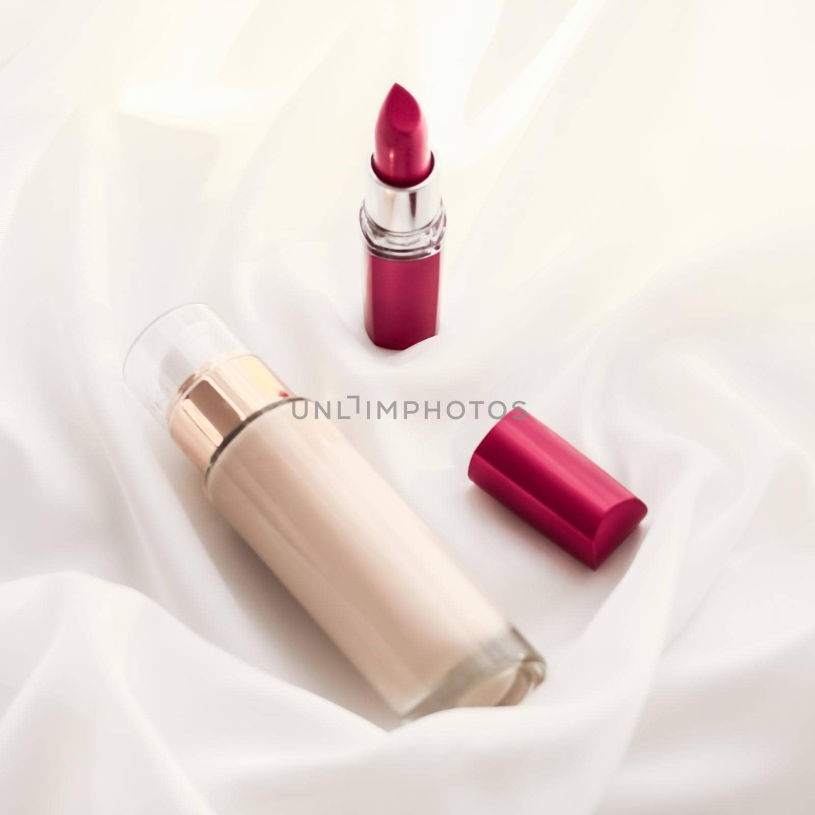 Cosmetic branding, glamour and skincare concept - Beige tonal cream bottle make-up fluid foundation base and red lipstick on silk background, cosmetics products as luxury beauty brand holiday design