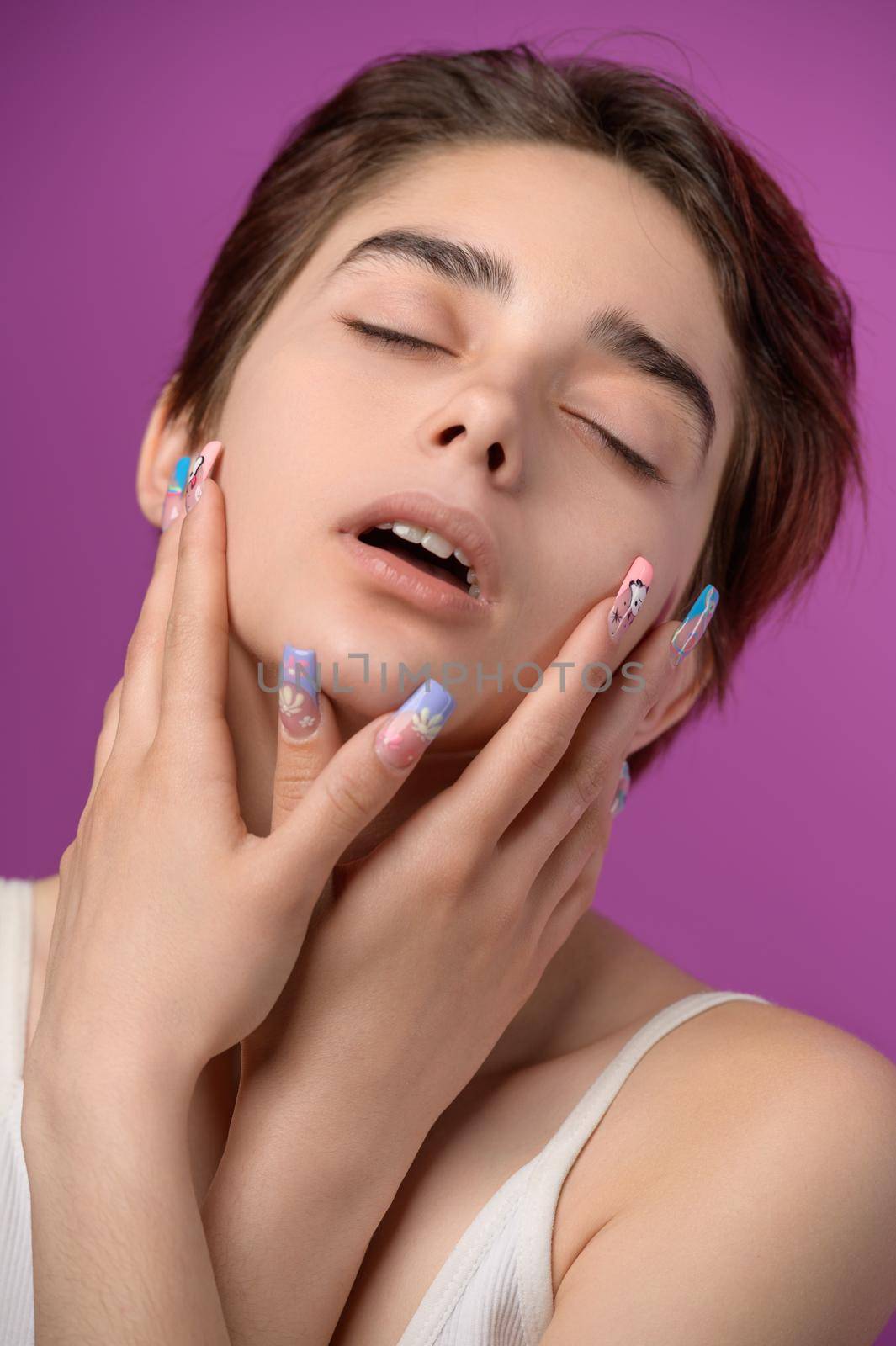 Sensual pretty girl with short haircut and extravagant nail art by starush