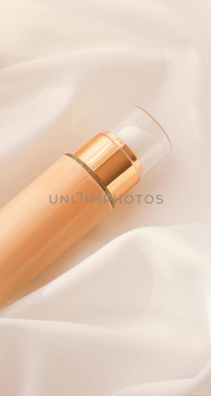 Tonal bb cream bottle make-up fluid foundation base for nude skin color on silk background, cosmetics product as luxury beauty brand holiday design by Anneleven