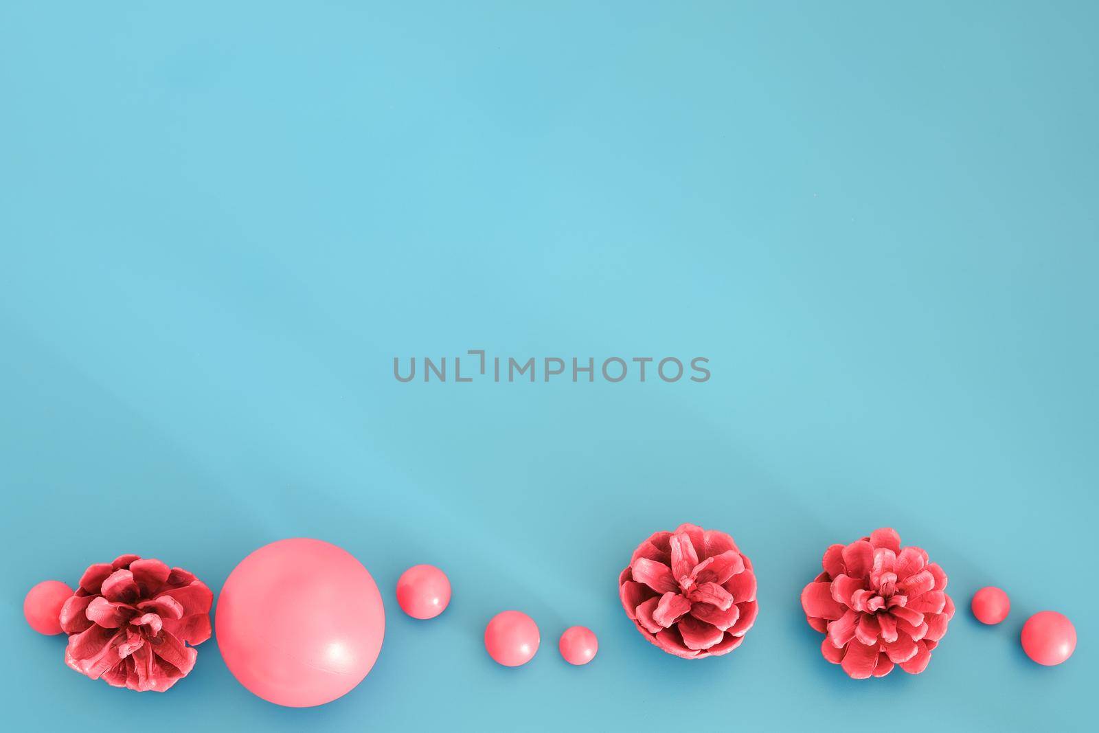 Pink Christmas composition on the blue background. Trendy Xmas background, mockup. Modern design. Free space for text, copy space. Flat lay, top view