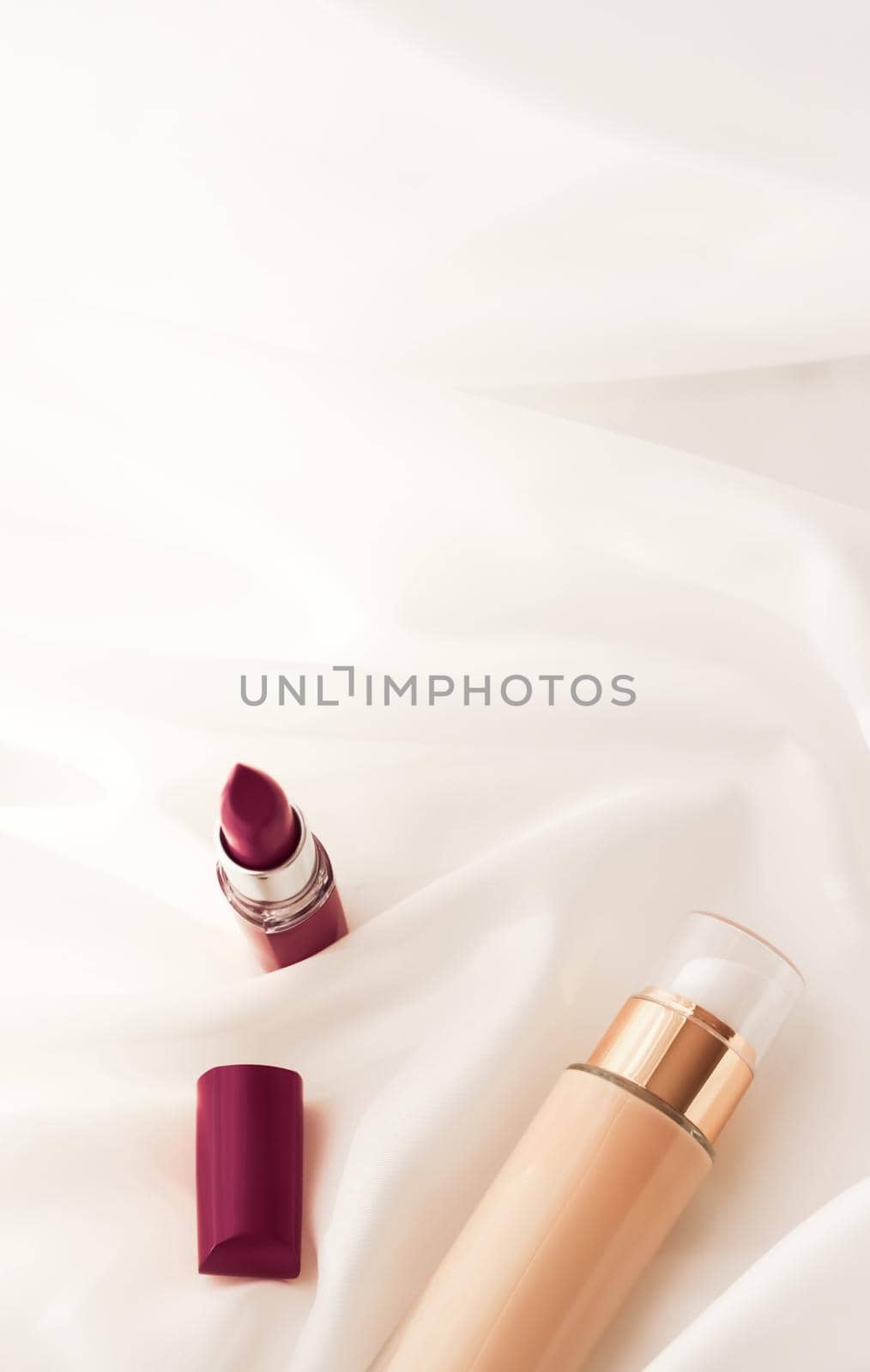 Cosmetic branding, glamour and skincare concept - Beige tonal cream bottle make-up fluid foundation base and dark lipstick on silk background, cosmetics products as luxury beauty brand holiday design