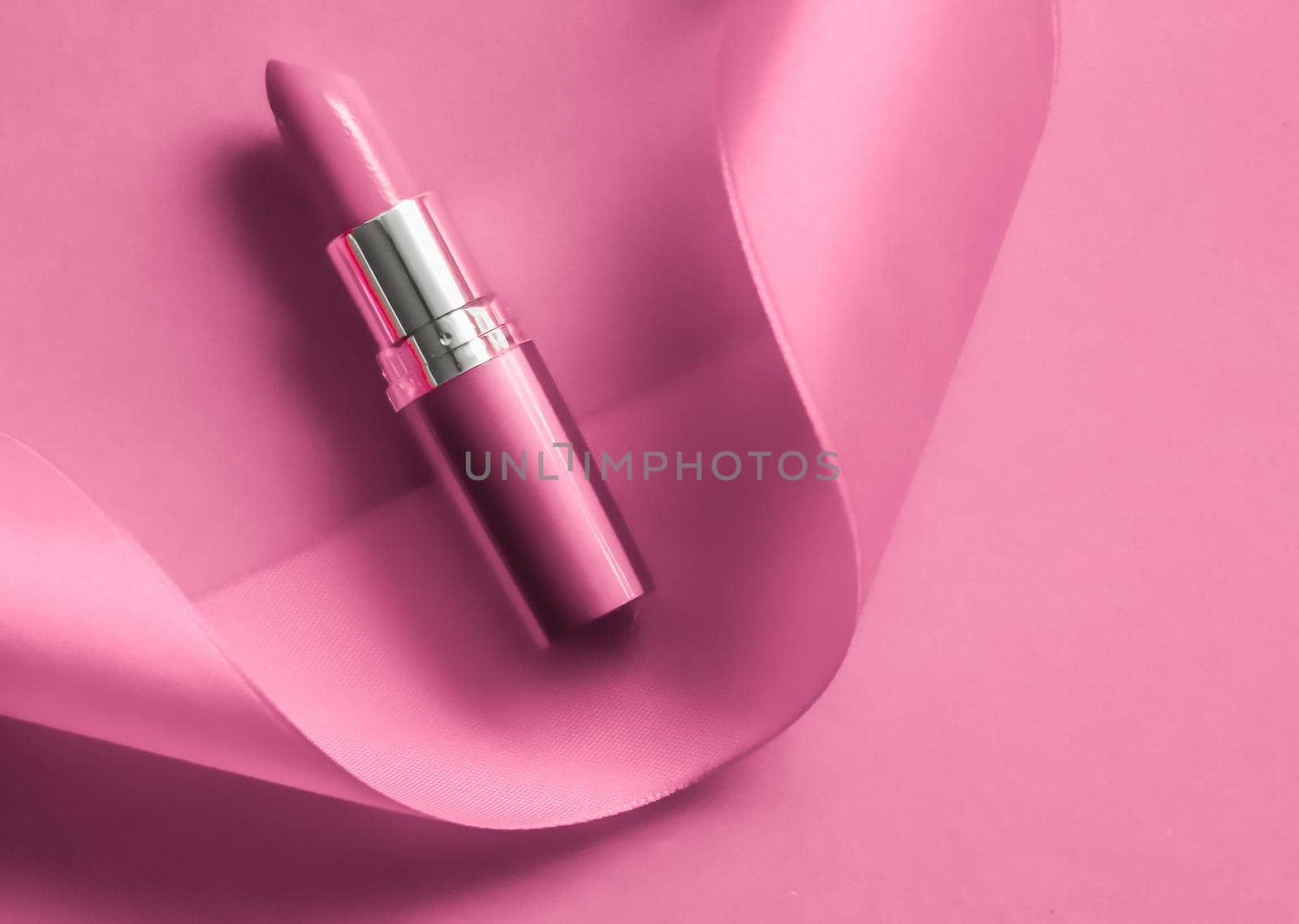 Cosmetic branding, glamour lip gloss and shopping sale concept - Luxury lipstick and silk ribbon on pink holiday background, make-up and cosmetics flatlay for beauty brand product design