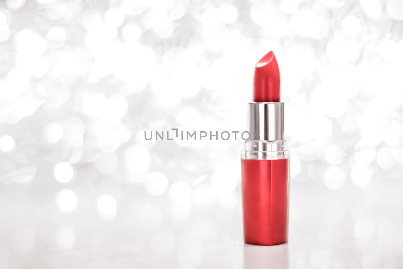 Cosmetic branding, sale and glamour concept - Coral lipstick on silver Christmas, New Years and Valentines Day holiday glitter background, make-up and cosmetics product for luxury beauty brand