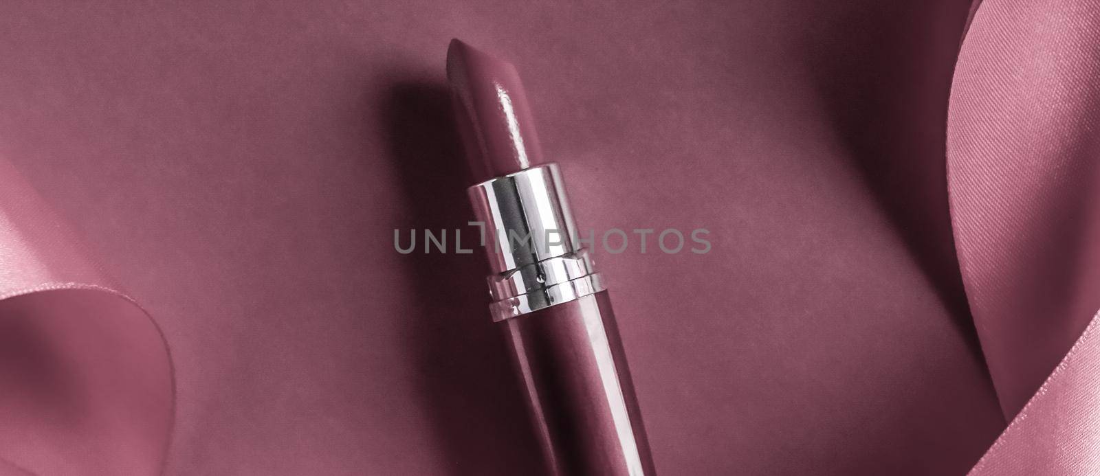 Cosmetic branding, glamour lip gloss and shopping sale concept - Luxury lipstick and silk ribbon on purple holiday background, make-up and cosmetics flatlay for beauty brand product design