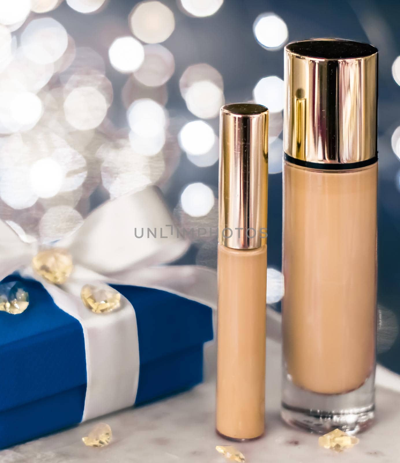 Cosmetic branding, Christmas glitter and girly blog concept - Holiday make-up foundation base, concealer and blue gift box, luxury cosmetics present and blank label products for beauty brand design