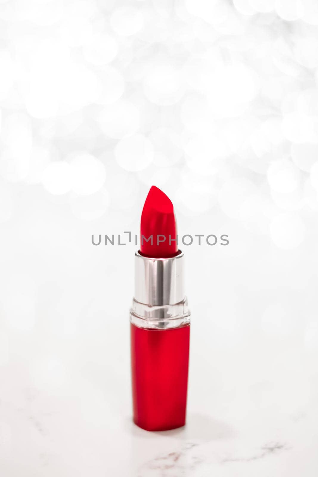 Red lipstick on silver Christmas, New Years and Valentines Day holiday glitter background, make-up and cosmetics product for luxury beauty brand by Anneleven