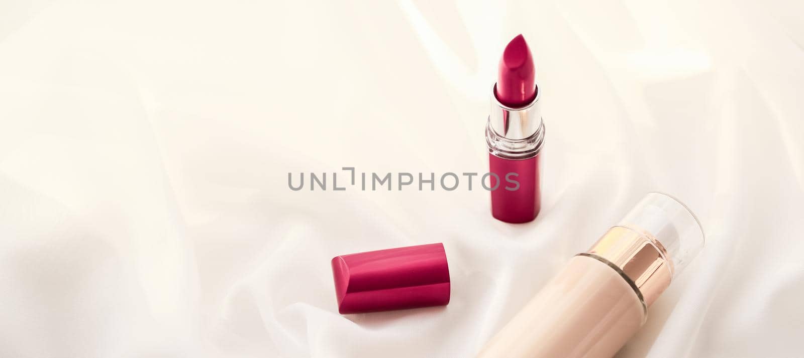Cosmetic branding, glamour and skincare concept - Beige tonal cream bottle make-up fluid foundation base and red lipstick on silk background, cosmetics products as luxury beauty brand holiday design
