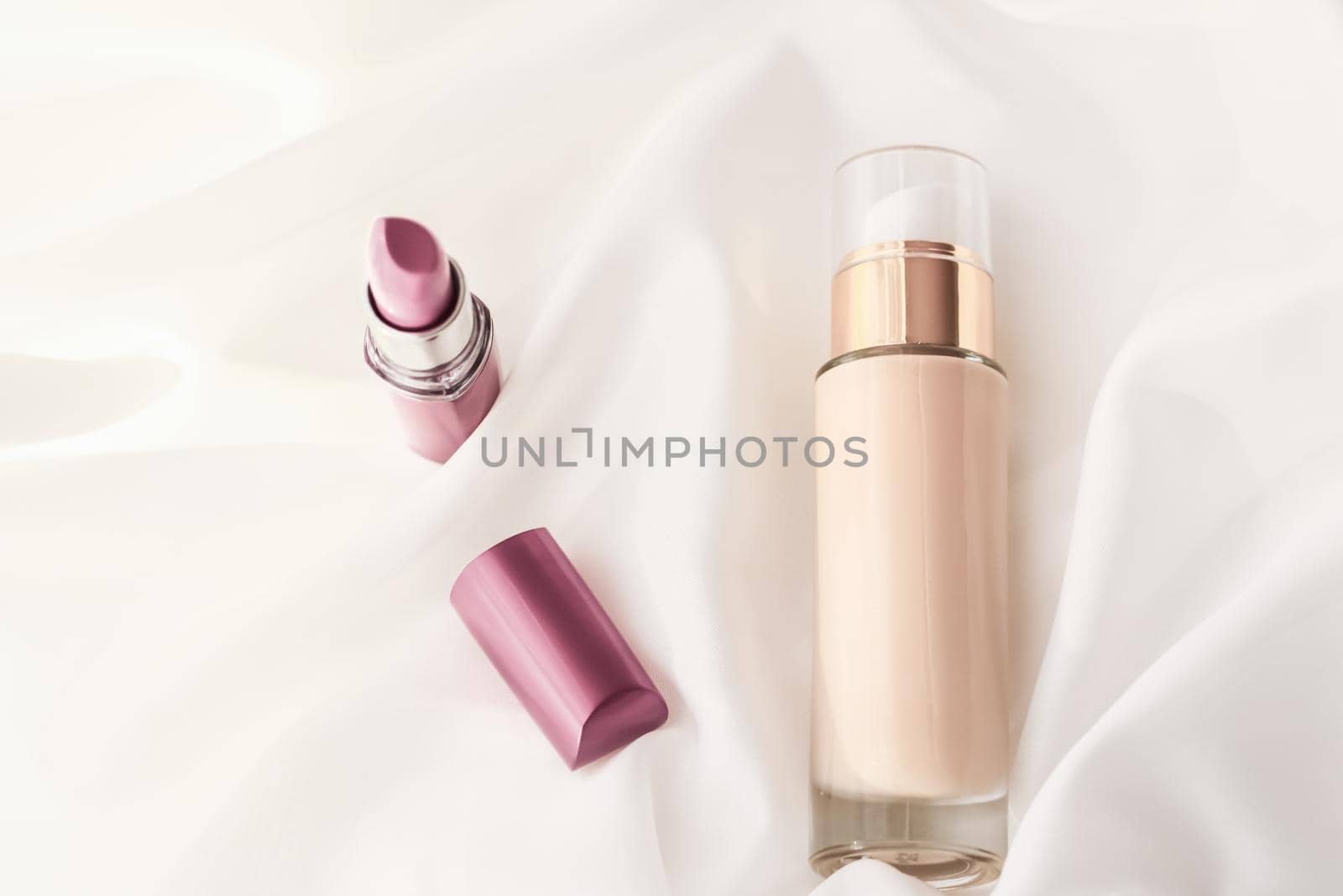 Cosmetic branding, glamour and skincare concept - Beige tonal cream bottle make-up fluid foundation base and pink lipstick on silk background, cosmetics products as luxury beauty brand holiday design