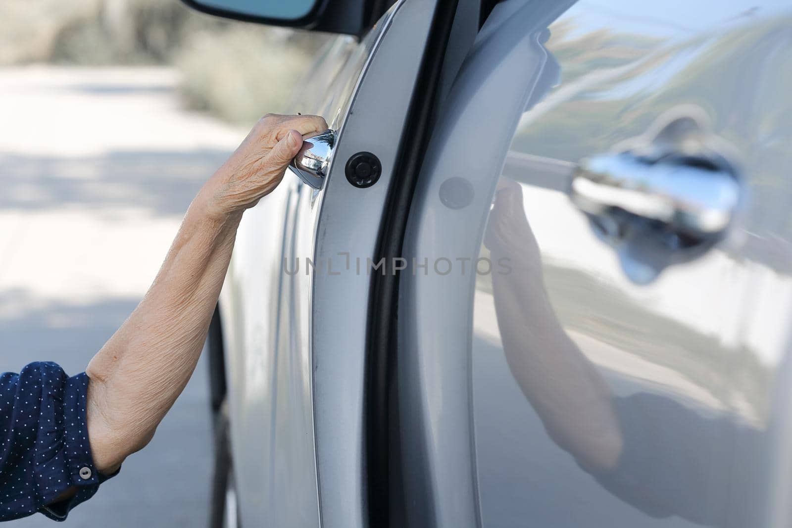 Elderly woman open door car