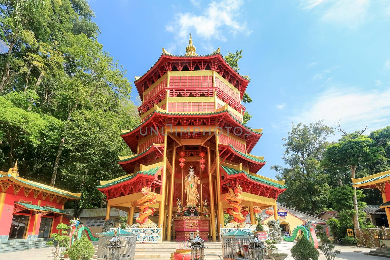 Chinese style pagoda with a giant statue of Guan Yin or goddess of compassion and mercy at Tiger Cave Temple (Wat Tham Seua) in Krabi, Thailand. by toa55