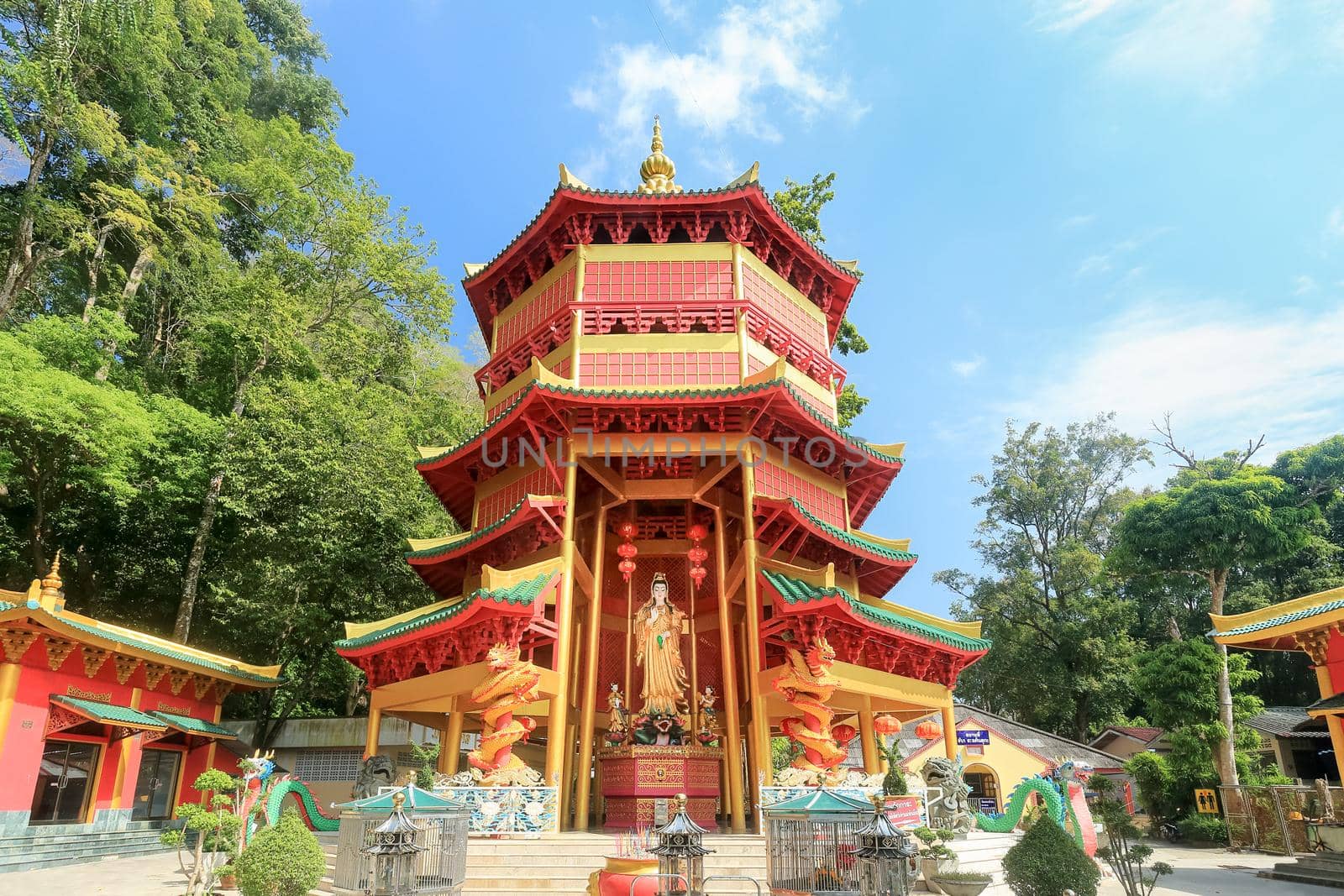 Chinese style pagoda with a giant statue of Guan Yin or goddess of compassion and mercy at Tiger Cave Temple (Wat Tham Seua) in Krabi, Thailand.